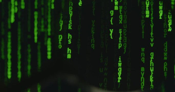 Looking at scrolling abstract computer code through a magnifier.