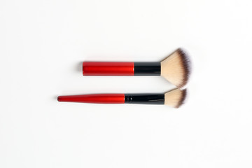 Red black makeup brush beauty accessories on white background