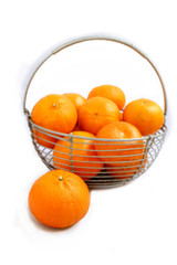 oranges in a meyal basket on white background,mandarin