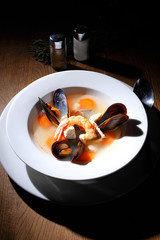 Healthy delicatessen seafood soup of white fish, shrimps and mussels