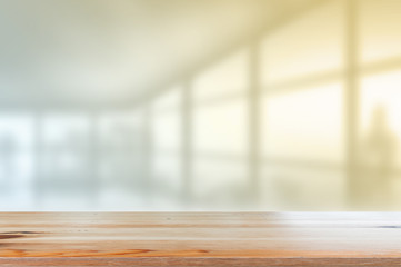 Wooden desk with Blurred of interior office room with city building background