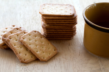 Milk cracker cookies Served with hot coffee on wooden desk ,Time break