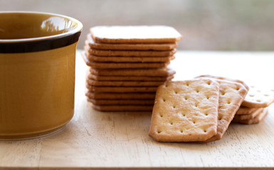 Milk cracker cookies Served with hot coffee on wooden desk ,Time break
