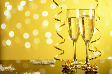 champagne glasses on yellow bokeh background with blurred background