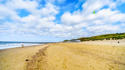  Man flying a kite on a beach at the harbor city of Vlissingen in Zeeland Province, the Netherlands © hpbfotos