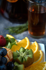 fruit plate. Glass bank of lemonade with sliced citrus fruits on a buffet table