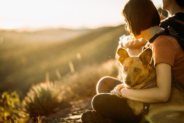 girl with dog at sunset