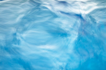 Fototapeta na wymiar The smooth natural blue water background with bokeh abstract on the sea or ocean,vintage and soft colored blur.