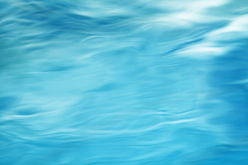 The smooth natural blue water background with bokeh  abstract on the sea or ocean,vintage and soft colored blur.