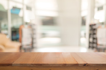 Wooden desk with Abstract blurred livingroom decoration interior for background