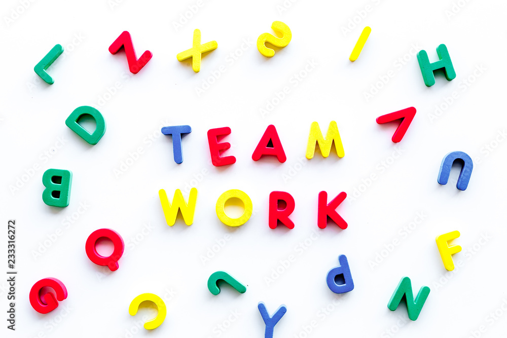 Poster teamwork training concept. text teamwork lined with colored letters in frame of toy letters on white