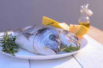 dorado fish on a black plate and wooden table