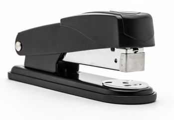 Office black stapler close up on a white background. - obrazy, fototapety, plakaty