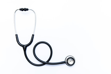 Close up view of black stethoscope on white back