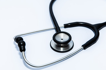 Close up view of black stethoscope on white back