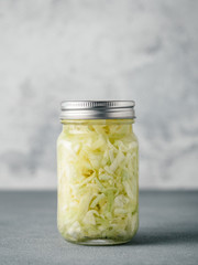 Sauerkraut in glass mason jar. Pickling cabbage at home on table. The best natural probiotic....