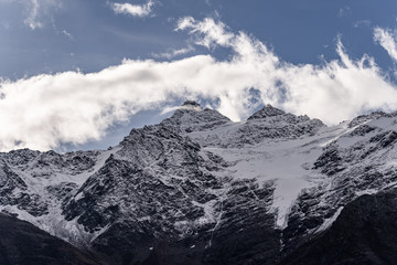 Obraz premium Amazing landscape of great caucasian mountain range. Amazing nature and ecology concept of big mountains with high rocks and blue cloudy sky in sunny day. Russia, Elbrus region.