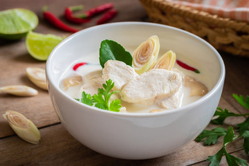 Chicken with coconut milk soup in white bowl, Thai food (Tom Kha Kai).