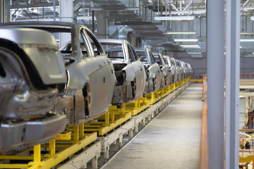 body of car on conveyor Modern Assembly of cars at plant. automated build process of car body