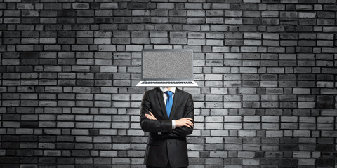 Businessman with laptop instead of head.