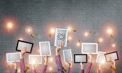 Close of woman hands in line showing tablet pc against concrete 