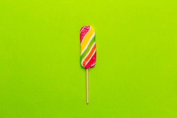 Colorful candies on green background