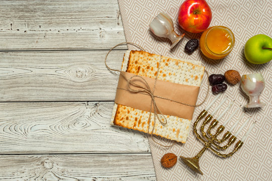 Jewish holiday Passover banner design with wine, matzo on wooden background.