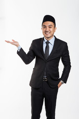 Asian business man in suit and songkok put his hands out