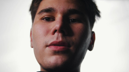 Obraz premium A man looking down in the camera. Bright light