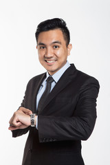 Man in business suit looking at his wrist watch