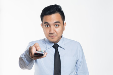 Man in office wear pointing a remote control