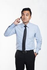 Asian man in office wear using his phone
