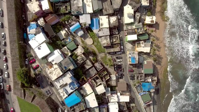Aerial shot moving over La Perla in Old San Juan, PR and towards El Morro