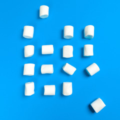 Fototapeta na wymiar Marshmallows on blue background