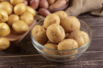 Fresh potatoes on the wood background