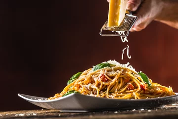 Crédence de cuisine en verre imprimé Plats de repas Italian pasta spaghetti with tomato sauce basil and parmesan cheese in white plate