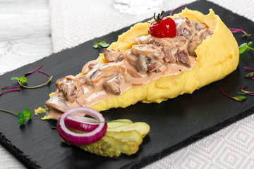 Close up of mashed potatoes with mushroom gravy