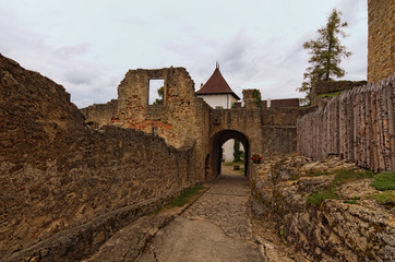Narrow way to the main courtyard of the Landstejn Castle. It is the oldest and best preserved Romanesque castle in Europe. Travel and tourism concept. Summer cloudy day. South Bohemian, Czech Republic