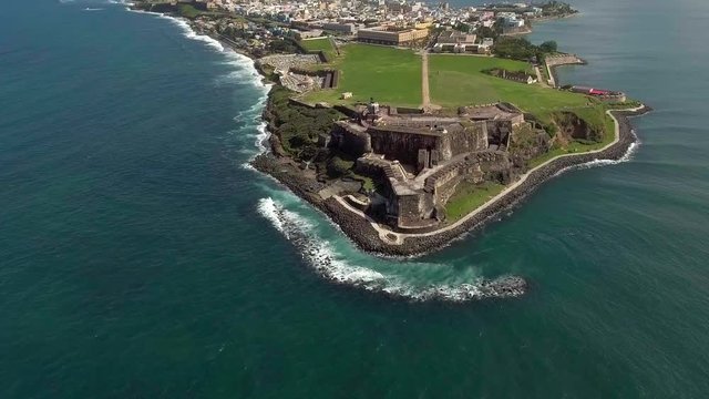 Aerial shot moving from the ocean and into El Morro in Old San Juan, Puerto Rico