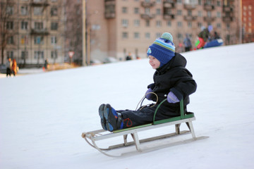 Fototapeta na wymiar boy riding a sleigh