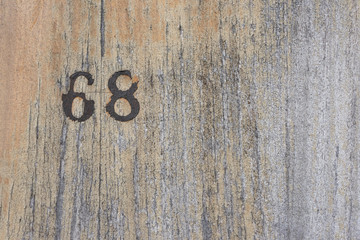 Number 68 on a wood texture background