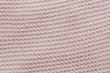 Pink texture of the knitted fabric. Horizontal view.