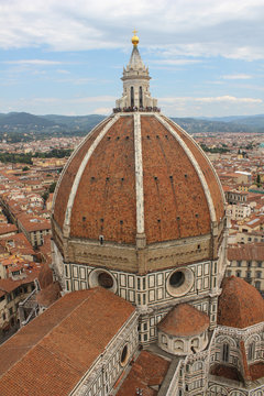 The cathedral on the background of the city./A large cathedral with a beautiful dome rises above the panorama of the city.