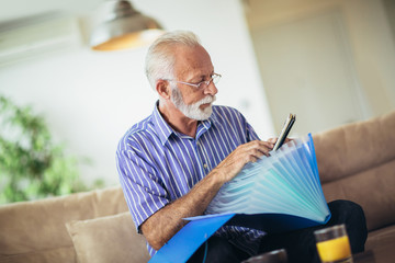 Senior man checking home finances.