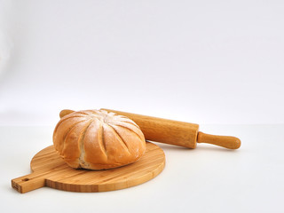 bread on wooden board with wheat
