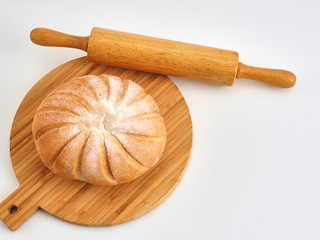 bread on wooden board with wheat