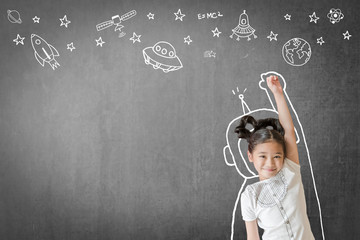 Kid's learning inspiration in science education with girl child's imagination doodle on teacher's...