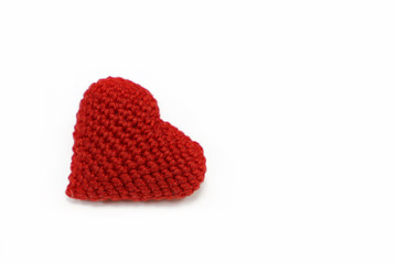 Red knitted heart isolated on white background. Symbol of romantic love, blood donation, health care, Valentine's day