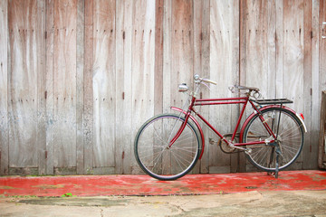 Naklejka na ściany i meble Vintage bycicle near old house at countryside in Thailand