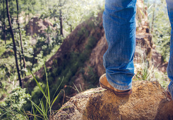 Close up shoes of hiker male standing on mountain